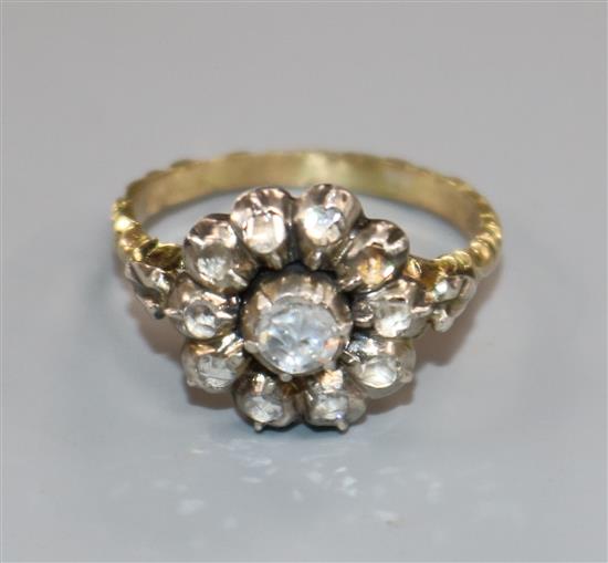A 19th century yellow metal and rose cut diamond set cluster ring, with carved shank, size L.